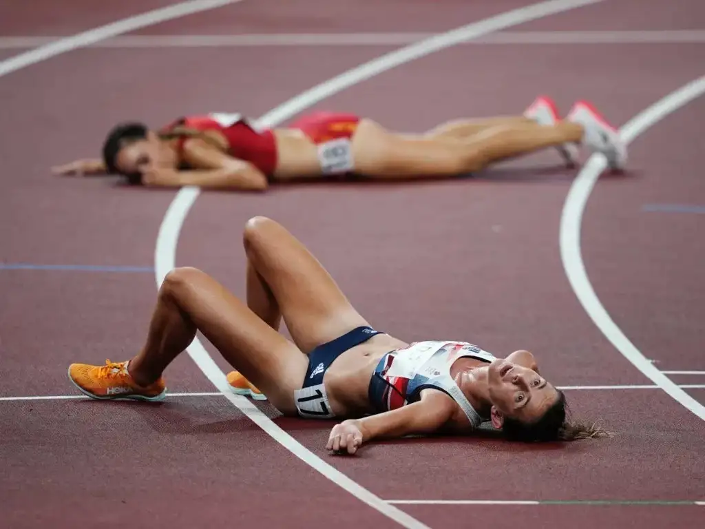 girl on the track resting after sprinting